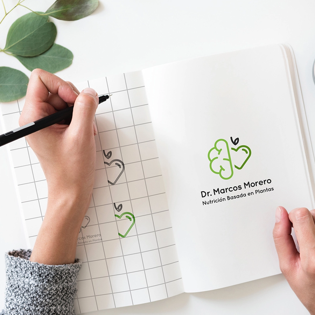Designer drawing a logo of a nutritionist green and health